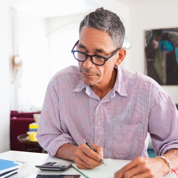A man works on paying bills.