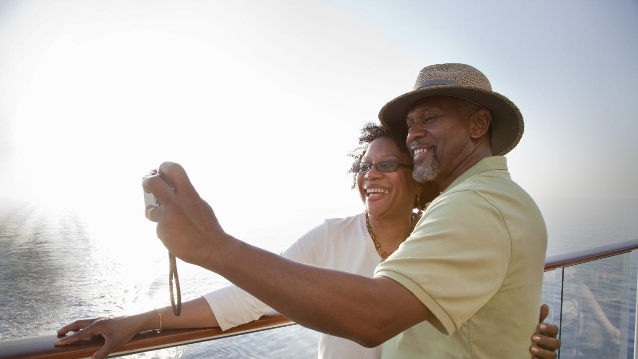 Older black couple taking a selfie together on a cruise ship.