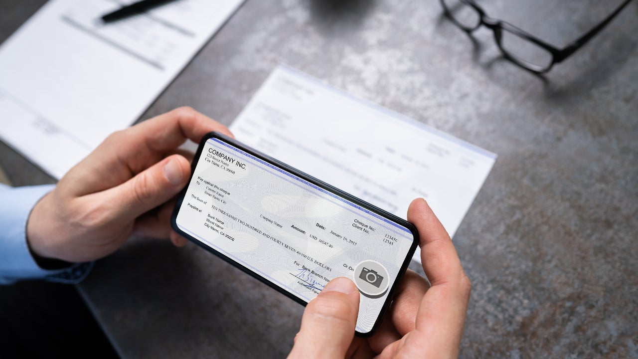 A person deposits a check with his smartphone.