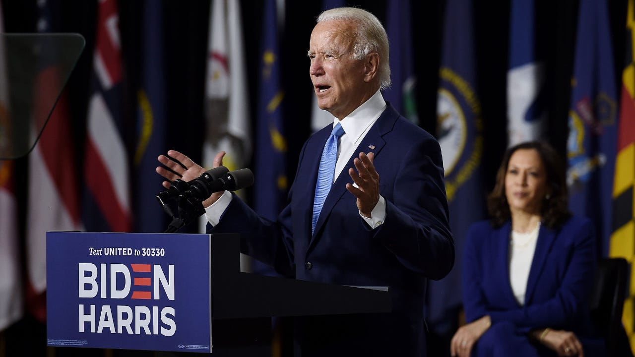 Former Vice President Joe Biden speaks at a press conference in Wilmington, Delaware, beside vice presidential running mate, U.S. Senator Kamala Harris.
