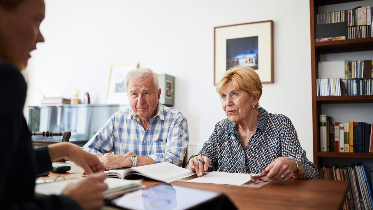 an older White couple talk with an adviser