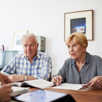 an older White couple talk with an adviser