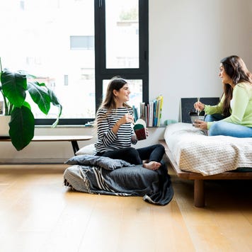 Two women having takeout food at home