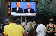 People sit and watch a broadcast of the first debate between President Donald Trump and Democratic presidential nominee Joe Biden.
