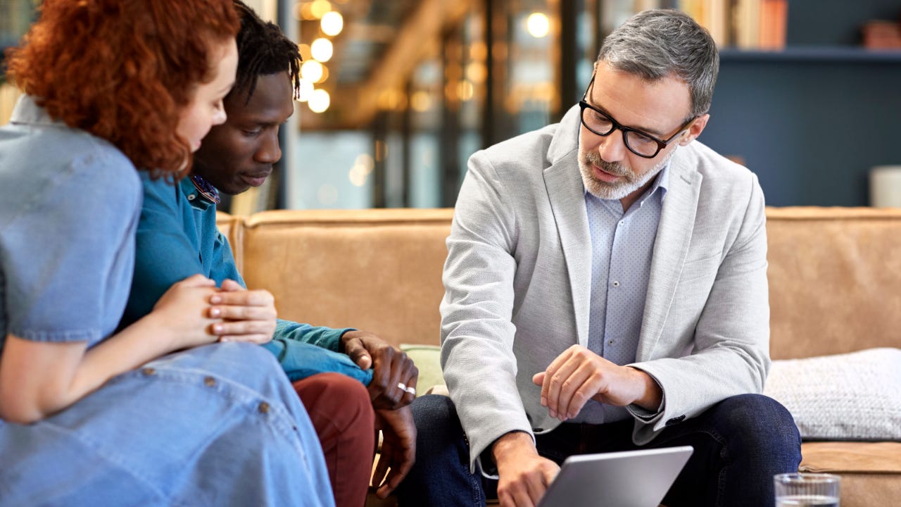 A financial adviser helps a couple with their finances