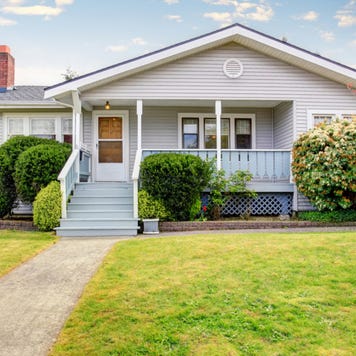 A single-story home with front porch and lawn