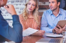 Young couple speaking to a banker