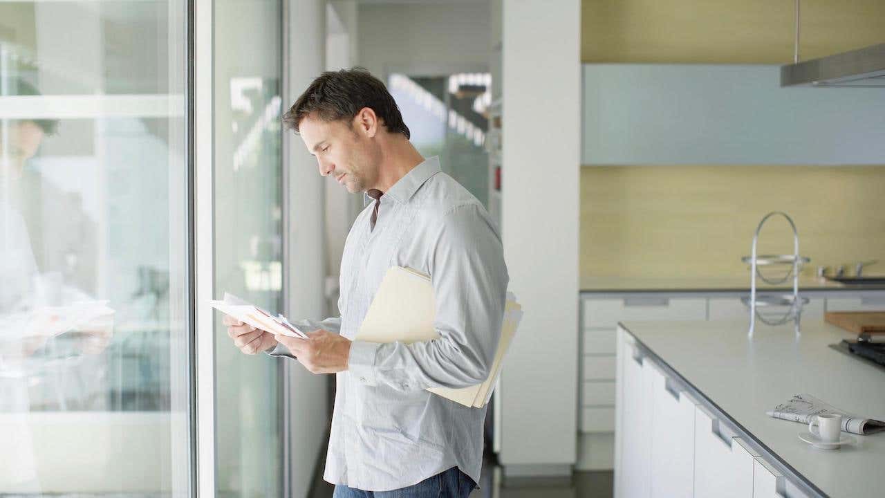 Man sorting mail at home