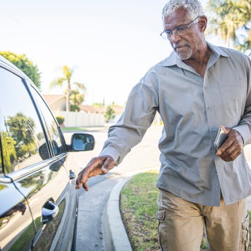 A man gets into a car.