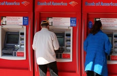 Customers visit a Bank of America ATM.