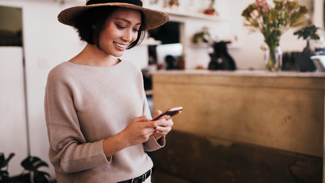 A woman looks at her phone.