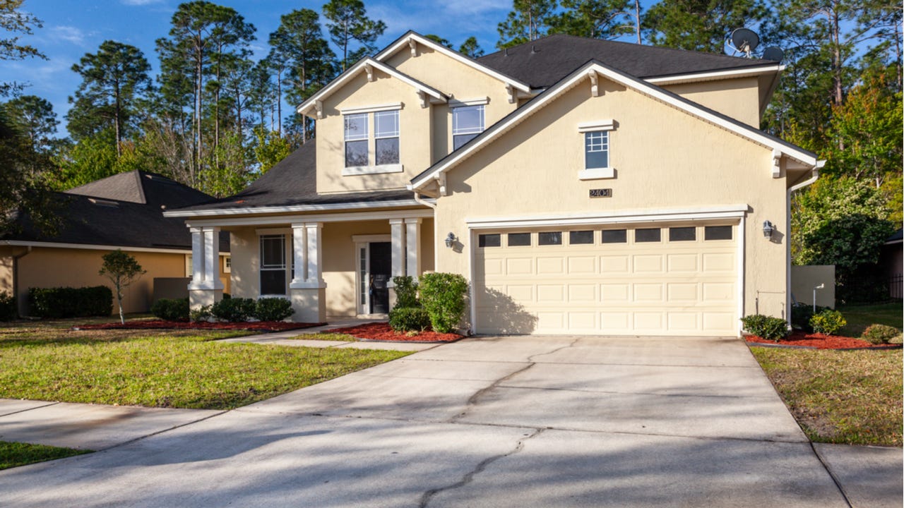 A two-story home with attached garage and columns