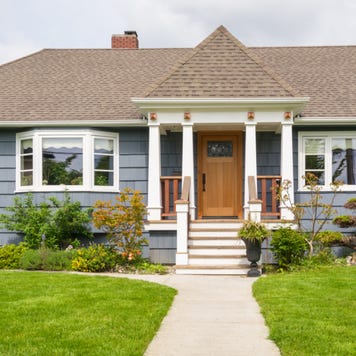 A single-story home with lawn and front path