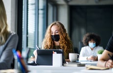 Woman studies while wearing mask