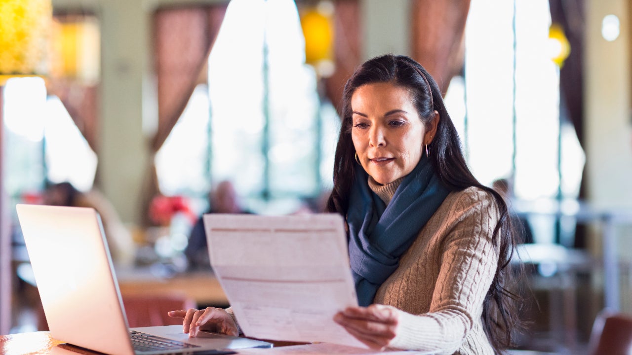 Woman paying bills using laptop.