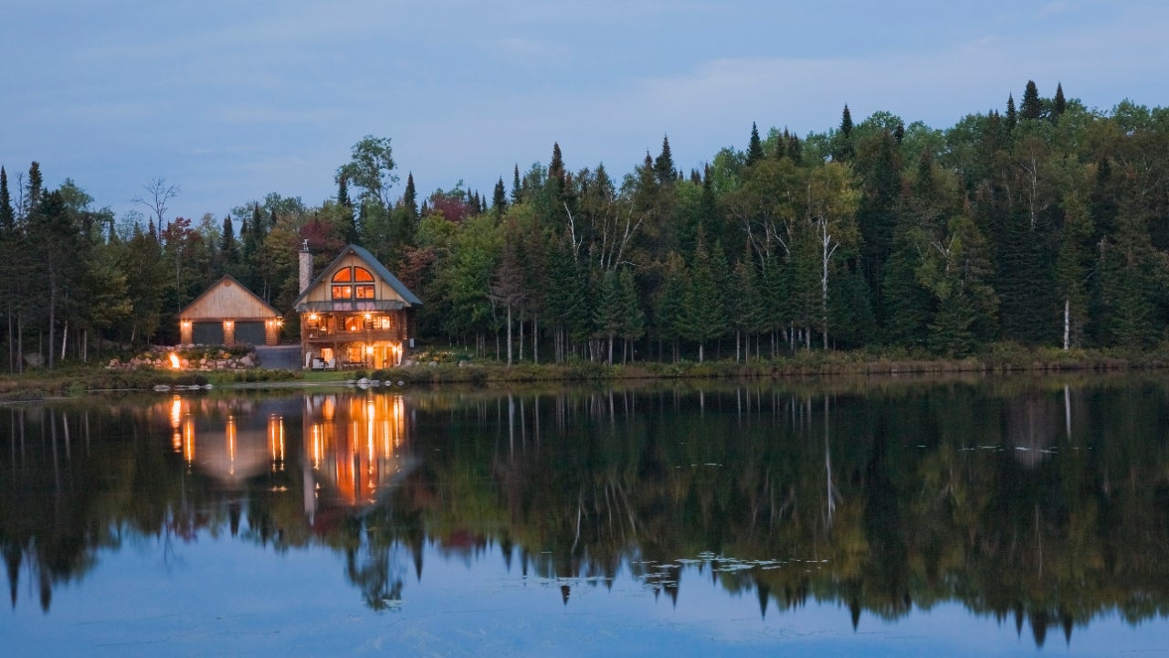 Lake home viewed at dusk across the water.