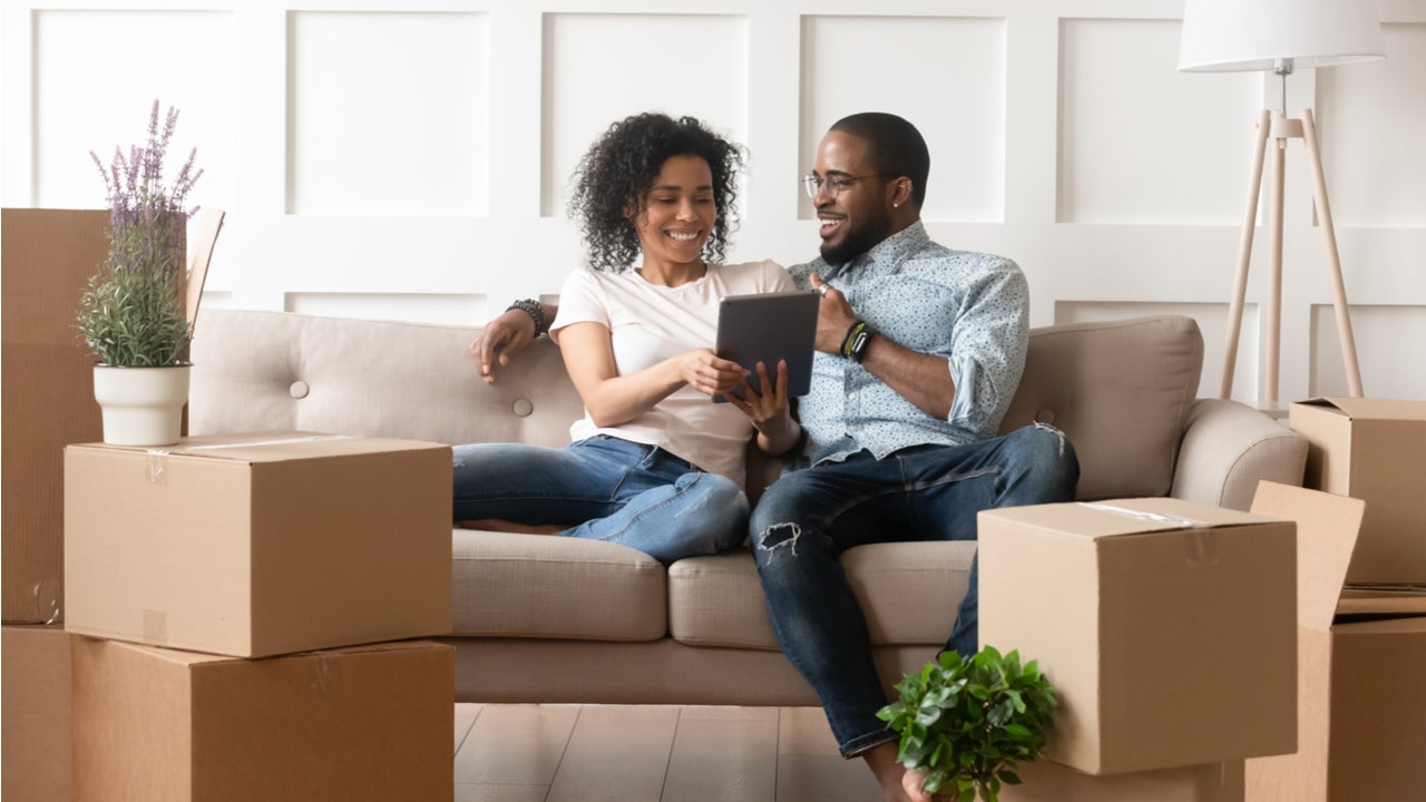 Couple looks at a tablet in a new home