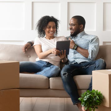 Couple looks at a tablet in a new home