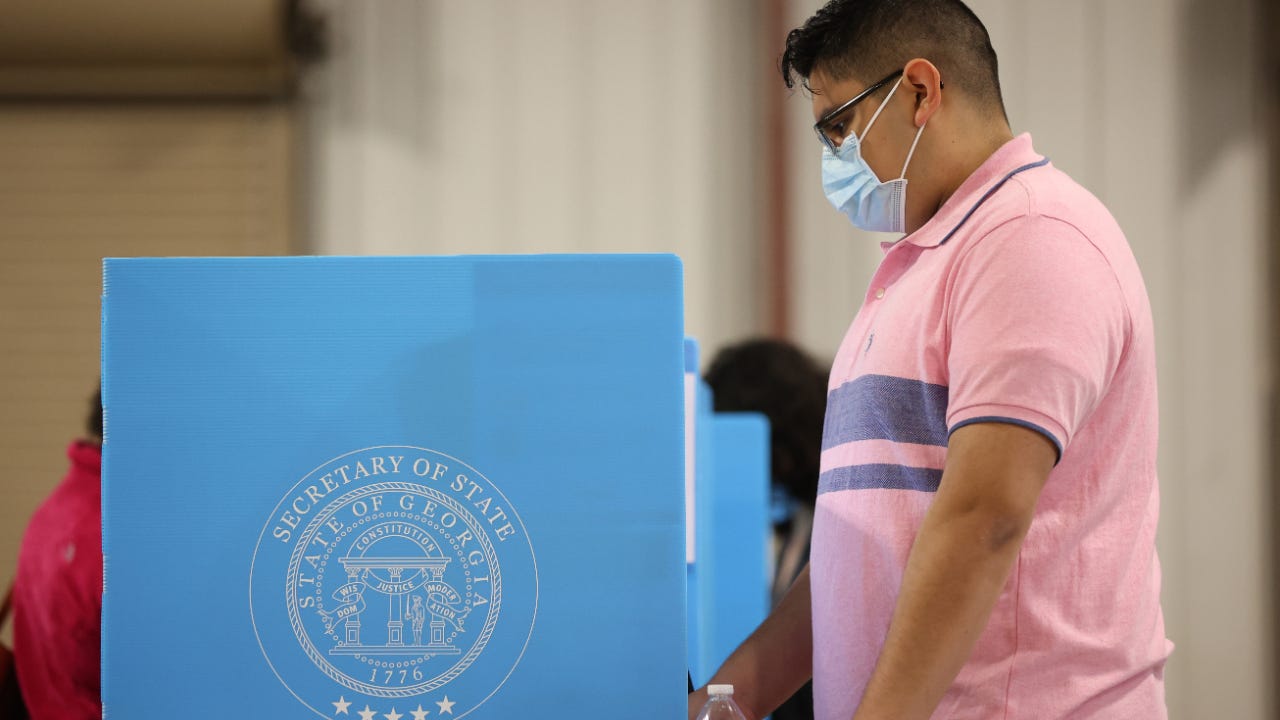 A voter casts his ballot.