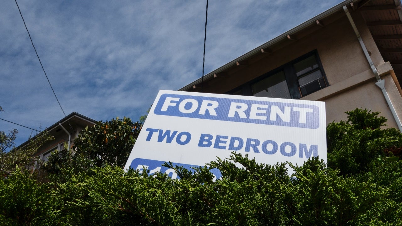 A for-rent sign outside of a two-bedroom home