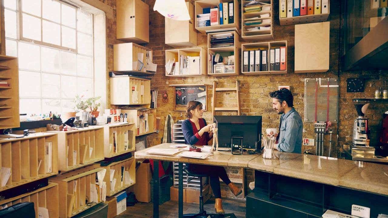 Two colleagues chatting in modern office