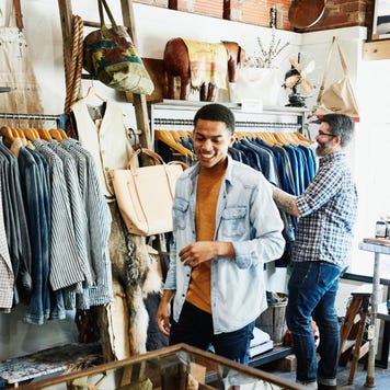 Smiling customers shopping in mens boutique