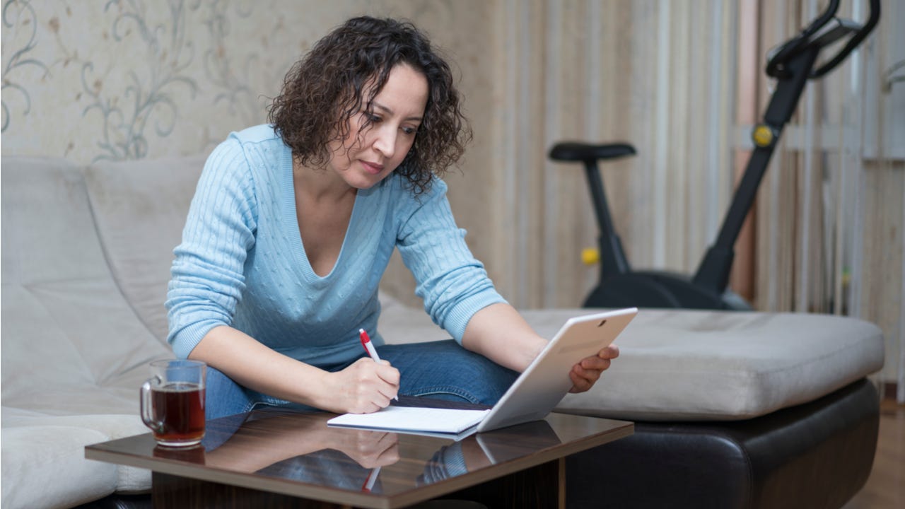 Woman works while looking at tablet