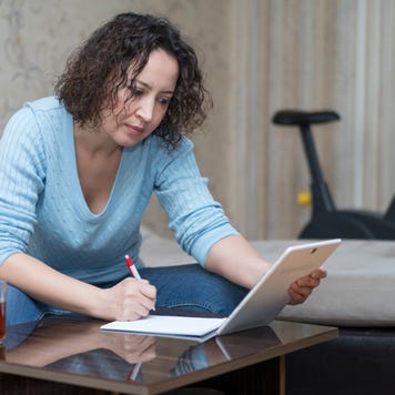 Woman works while looking at tablet