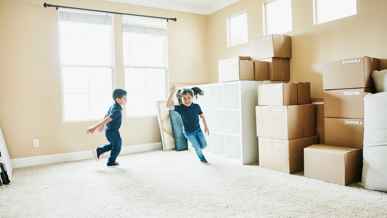 Children playing in an empty house on moving day