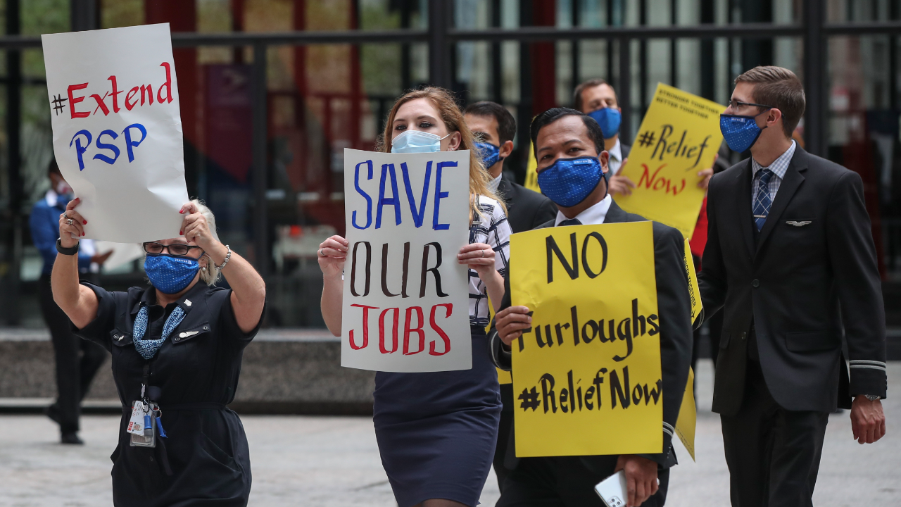 Airline industry workers hold signs during a protest in Chicago