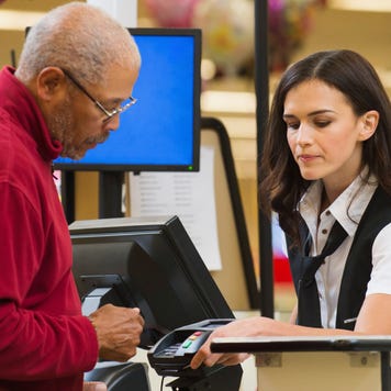 Cashier and customer at grocery store checkout