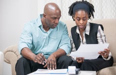 A Black couple reviews financial documents