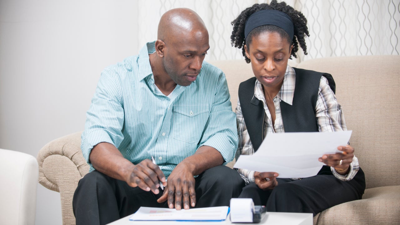 A Black couple reviews financial documents