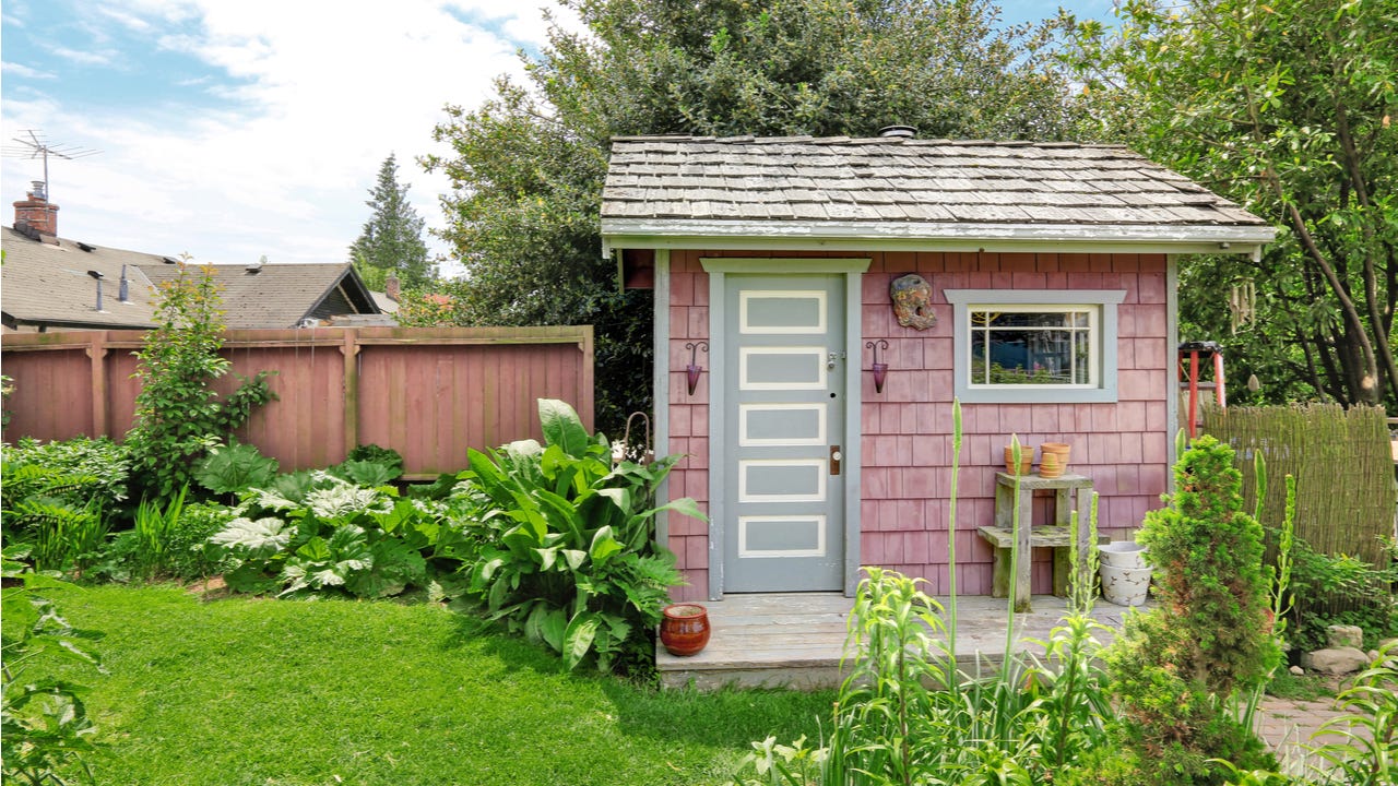 Pink shed in a backyard garden