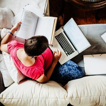 A woman looking over documents from above