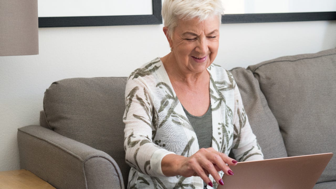 A senior works on her laptop.