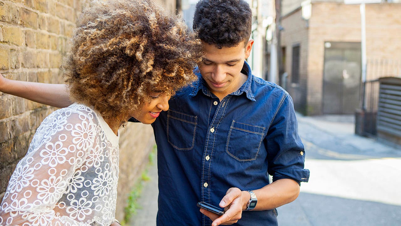 young couple looking at phone