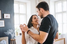 A White couple dances in their living room