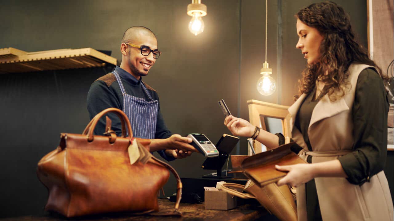 Woman paying with credit card at store