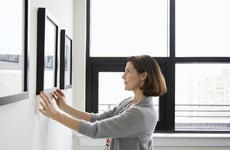 Woman hanging pictures