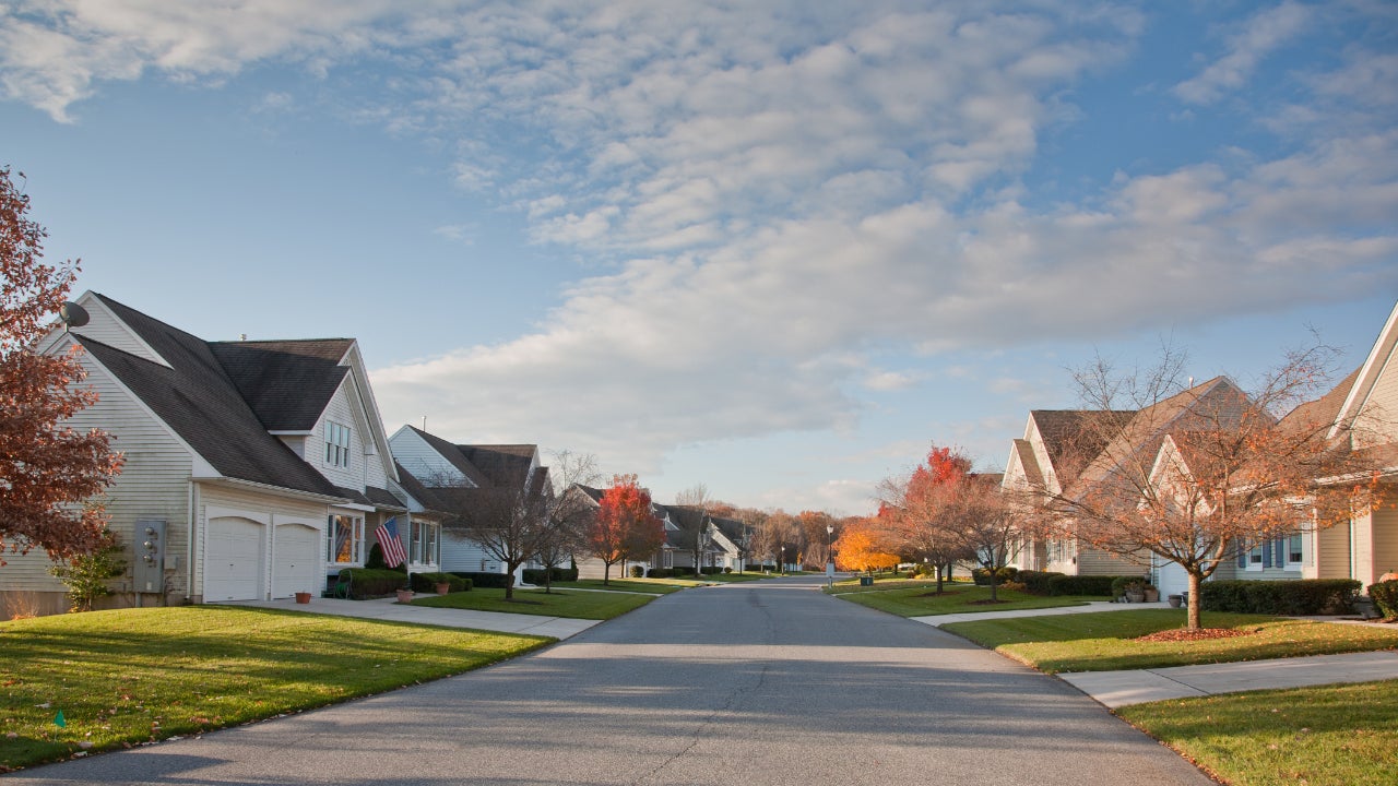 Suburban homes on a street with fall foliage.