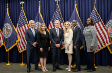 Members of the Federal Reserve Board of Governors stand with Fed Chair Jerome Powell after he was sworn in for his second term.
