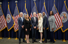 Members of the Federal Reserve Board of Governors stand with Fed Chair Jerome Powell after he was sworn in for his second term.