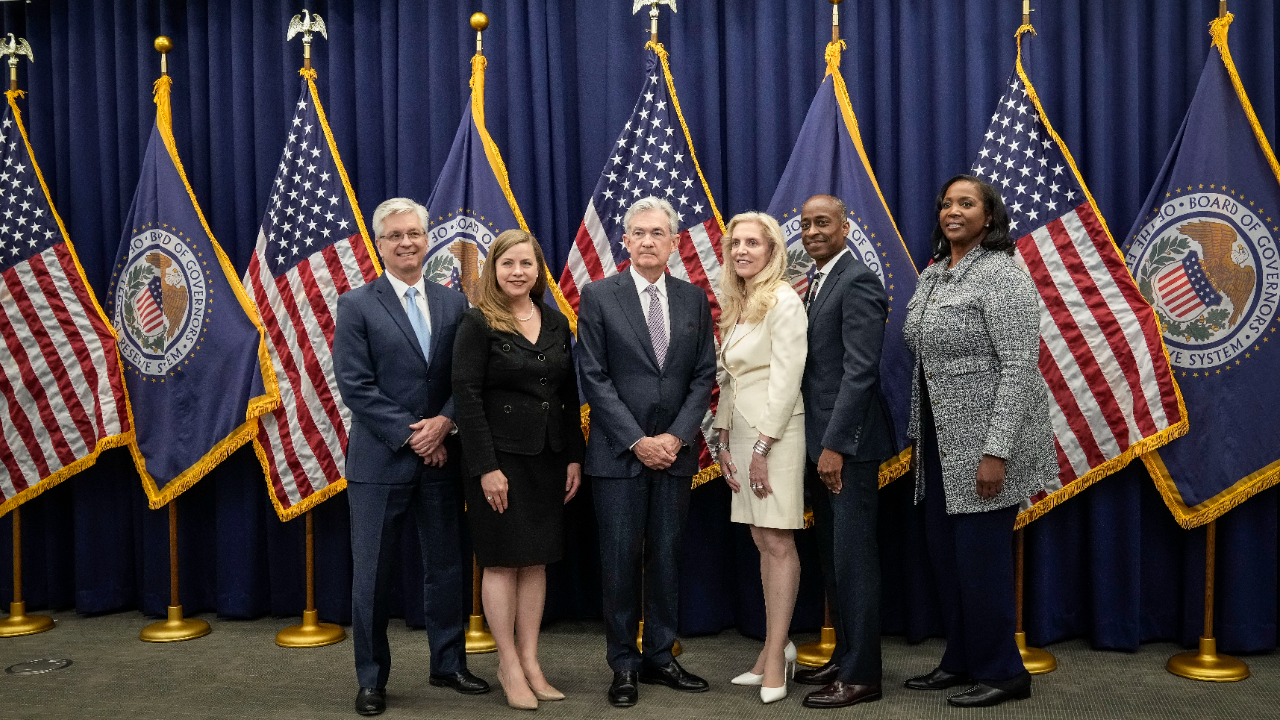 Members of the Federal Reserve Board of Governors stand with Fed Chair Jerome Powell after he was sworn in for his second term.