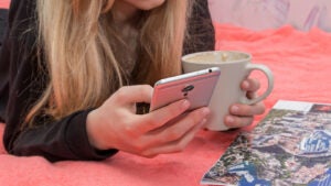 A young woman works on her smartphone.