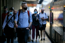 Commuters arrive at South Station in Boston wearing masks.