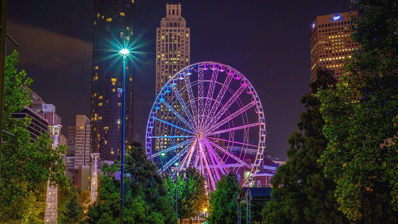 Ferris wheel all lit up in Atlanta at night.