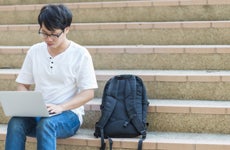 College student sits on campus steps