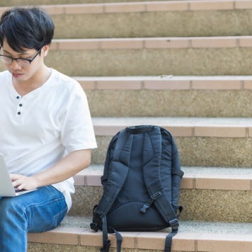 College student sits on campus steps