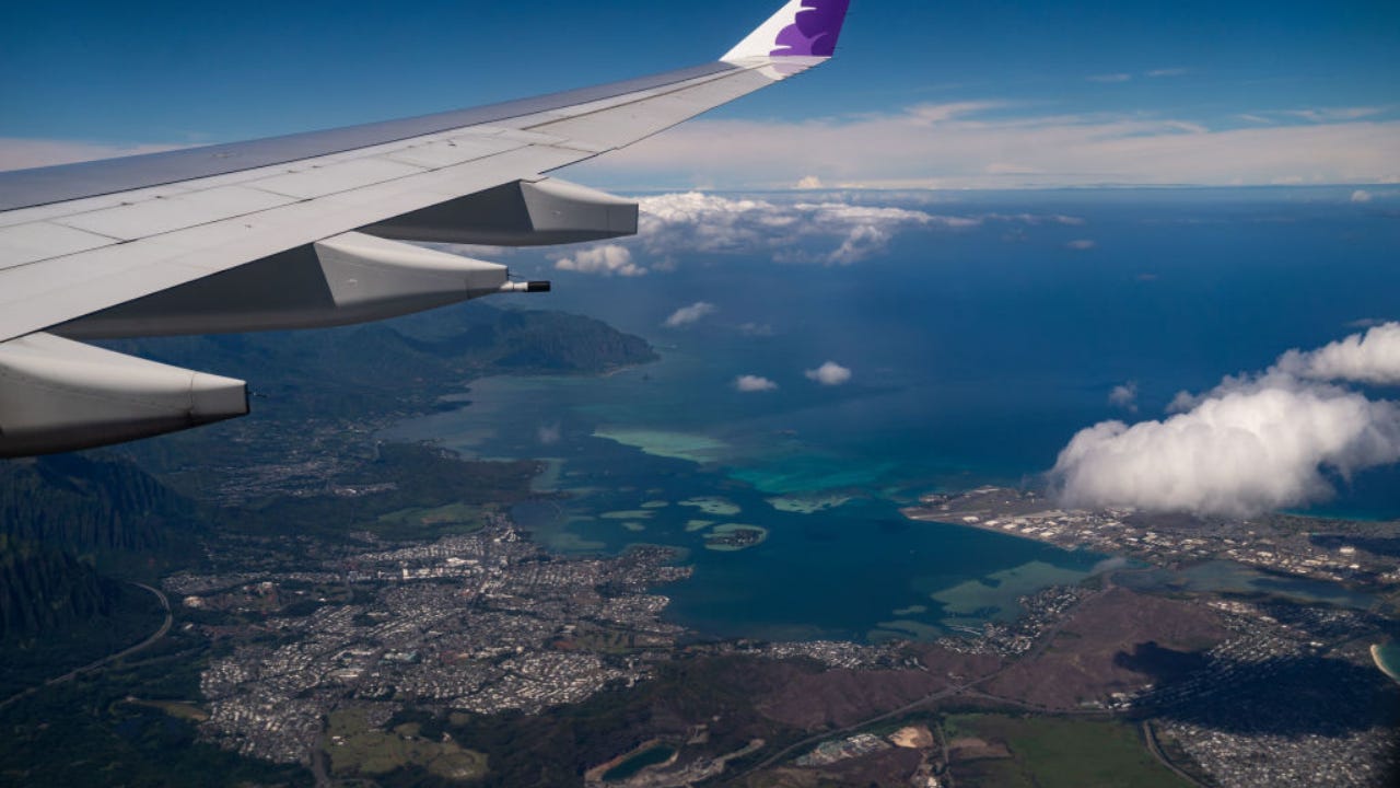 A Hawaiian Airlines plane flying over Honolulu.